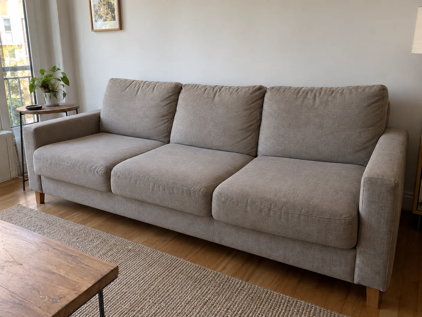 The same three-seat grey-beige fabric sofa with clean upholstery and its natural texture
